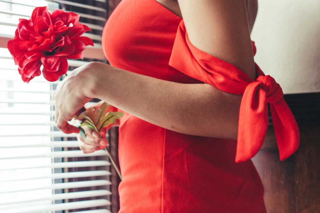 Close up of sleeve tie details on red dress, perfect for a night out with your significant other.