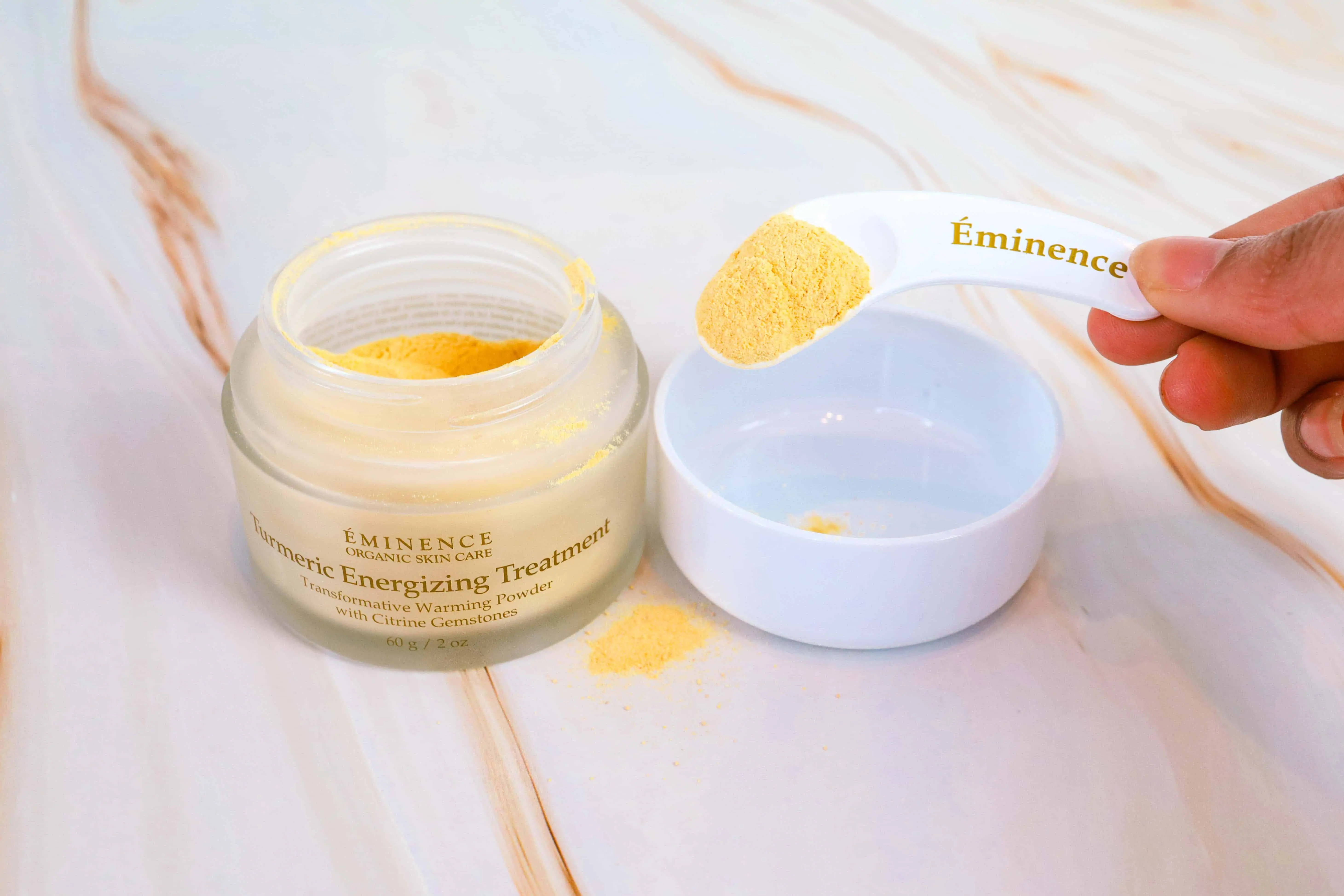 Black Blogger holding Eminence Spoonful of Turmeric Energizing Treatment.