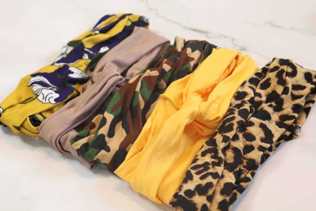Five Random LuvMe Hair Headband Wig Headbands. Yellow and Purple Pattern, Taupe, Army Print (camouflage), Yellow, Cheetah Print.