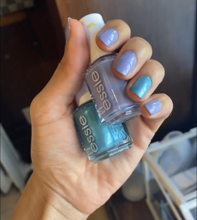 Hand holding Essie Nail polishes - In Pursuit of Craftiness and Main Attraction