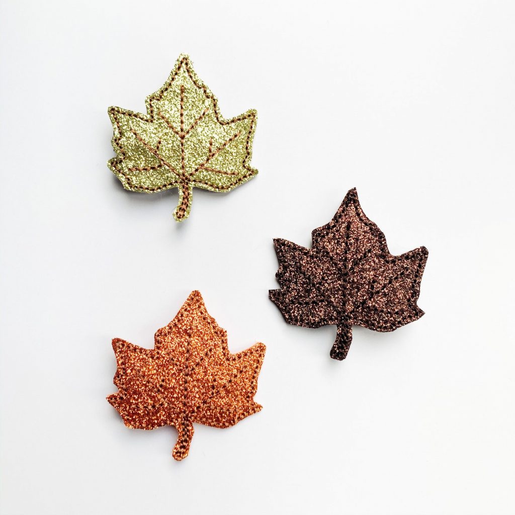 Fall Hair clips, glittery and shaped like fallen leaves.