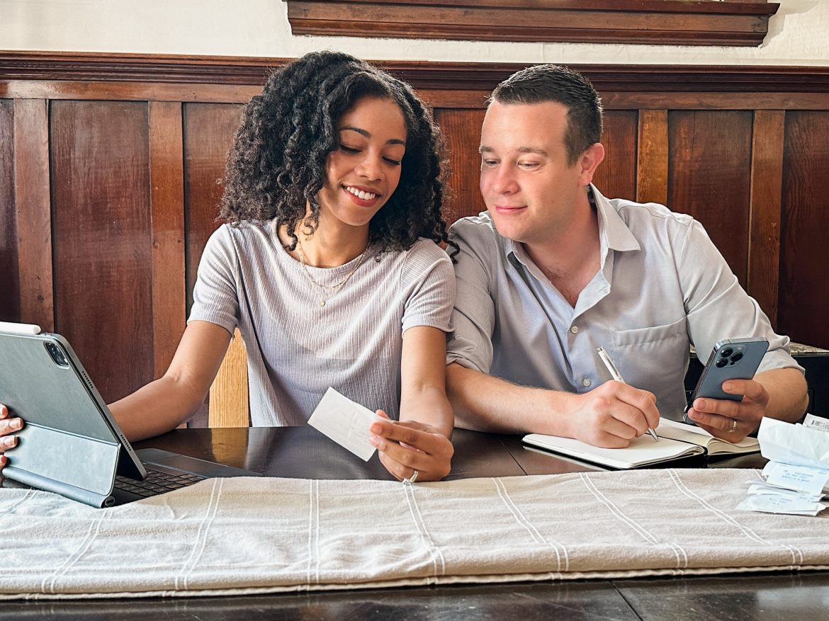 Things Couples Should Consider Before Combining Finances. Sitting down going over expenses